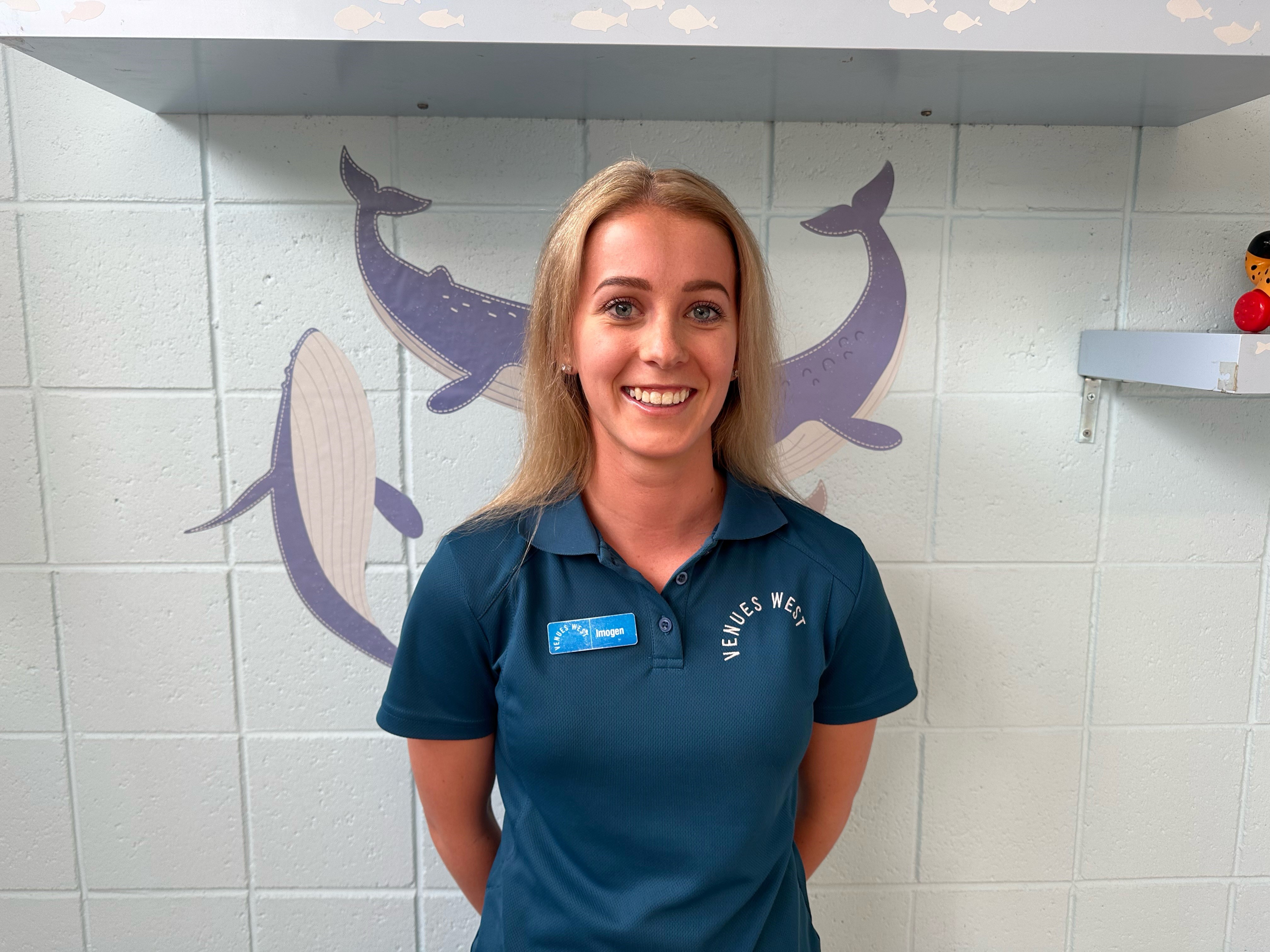 A photo of a lady posing for a photo wearing a VenuesWest branded shirt